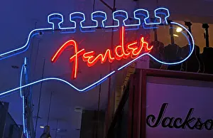 Guitars Prints: Fender Guitar Neon Sign in blue and red / orange, in a music shop