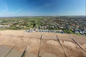 Beach Huts Prints: Ferring seafront on the English Channel with the Ferring Rife running next to the village of Ferring