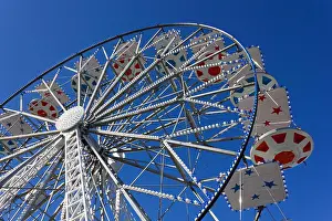 Ferris Wheel Prints: Ferris wheel decorated in red and blue against a blue sky