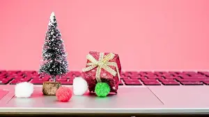 New Party Prints: A festive display includes a tiny Christmas tree and a wrapped gift on a laptop keyboard