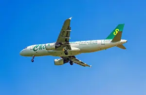 Airlines Prints: FILE--An Airbus A320 passenger jet of Spring Airlines prepares to land at the Shenzhen Baoan International Airport