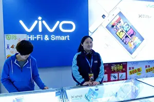 Producer Prints: FILE--Chinese employees are pictured at a mobile phone store of Vivo in Qingdao city