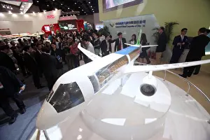 FILE--Visitors look at a model plane of the C919 on display at the stand of COMAC