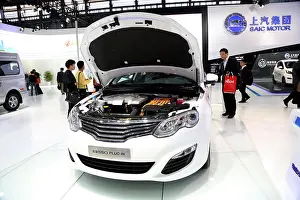 Clean Energy Prints: FILE--Visitors look at a Roewe 550 Plug-in hybrid car of SAIC Motor on display at the 16th China International