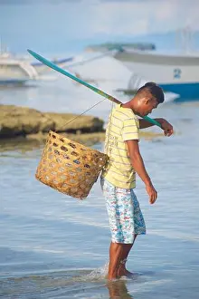 Filipino Prints: Filipino fisherman with a basket with fishing line and an oar heading out to his boat