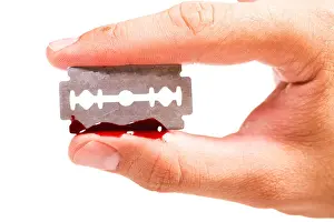 Blade Prints: fingers keep the old rusty razor with blood on a white background