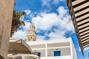 Images Dated 10th May 2019: Fira town in Santorini clock tower with white architecture. idyllic city exterior view from street