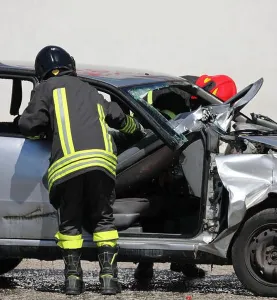 Motorcar Prints: firefighters in action and the crashed car completely destroyed after the traffic accident on the highway