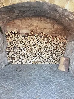 Stockimo Prints: Firewood stock in a medieval vaulted cellar