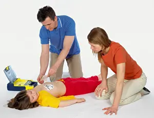 Kneeling Prints: First aid, using paediatric defibrillator
