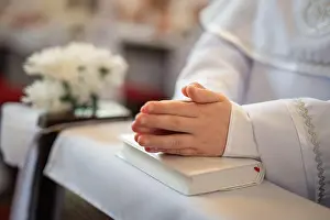 Communion Prints: first holy communion, child's hands on the book preyer during the prayer