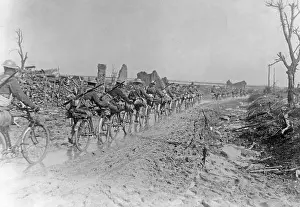Cyclists Prints: First World War 1914-1918. British soldiers with their bicycles are walking on a muddy road somewhere in France