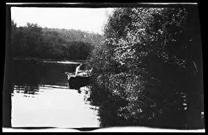1880 Prints: A fisherman sits in a small boat on a pond within a rural waterscape recorded in Georges Maroniez archive