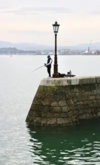 Sea Wall Prints: Fisherman using rod