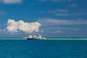 Fishing in the blue waters, tropical fishing boats over exotic lagoon and coral reef edge