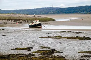 Seawater Prints: Fishing boat stranded in shallow water channel at low tide in Red Wharf Bay