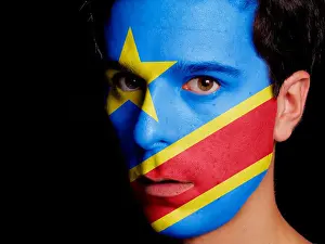 Supporter Prints: Flag of Democratic Republic of Congo Painted on a Face of a Young Man