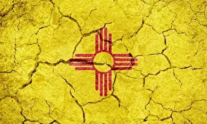 Flag of the U.S. state of New Mexico on dry earth ground texture background