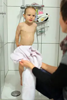 Schleswig Holstein Prints: Flensburg, Germany, a boy is washed by his mother in the shower