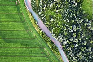 Flight through majestic Ukrainian landscape with river Dnister and green fields at sunset time. Summertime