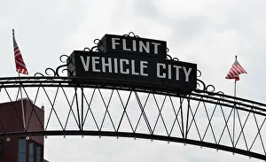 FLINT, MI - AUGUST 22: Flint Vehicle City sign, shown here on August 22, 2015, spans downtown Flint, MI