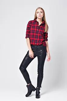 Flexibility Prints: Flirtatious young blonde woman posing in red flannel shirt and black jeans. haughty look