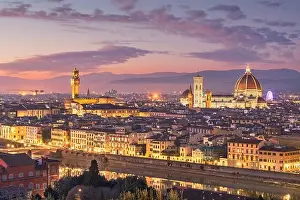 Florence, Italy skyline with landmark buildings at dusk over the Arno River