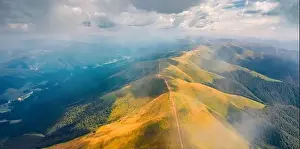 Unbelievable Prints: Flying under the clouds. Panoramic summer view from flying drone of Krasna range with old country road