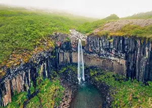 Torrent Prints: Foggy morning view from flying drone of famous Svartifoss (Black Fall) Waterfall
