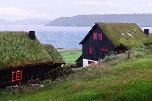 Foggy morning view of a house with grass roof in the Velbastadur village on Streymoy island, Faroe islands, Denmark. Landscape photography