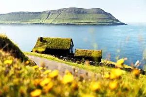 Foggy morning view of a house with grass roof in the Velbastadur village on Streymoy island, Faroe islands, Denmark. Landscape photography