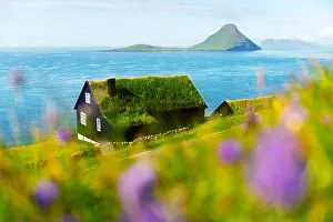 Foggy morning view of a house with typical turf-top grass roof in the Velbastadur village on Streymoy island, Faroe islands, Denmark