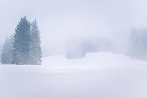 European Alps Prints: Foggy snow covered mountain lasndscape in winter. Extreme winter weather