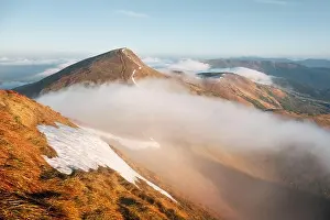 Foggy spring mountains during sunrise. A soft mist flows through the mountain peaks. Carpathian mountains, Ukraine. Landscape photography
