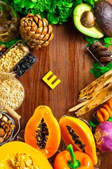 Avocado Prints: Foods containing and rich in vitamin E on a wooden board. Health food concept