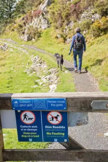 National Parks Prints: Footpath signs asking walkers to keep their dogs on a lead in the countryside