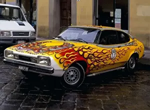 A Ford Capri, customised in flaming red and yellow and with rooftop devil's horns