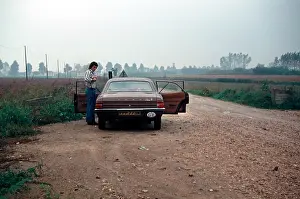 Ford Cortina from the 1970s in Italy early morning countryside man standing alongside
