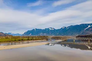 Fraser River close to the city of Agassiz with the Agassiz Rosedale Highway bridge and Mount Cheam on the background