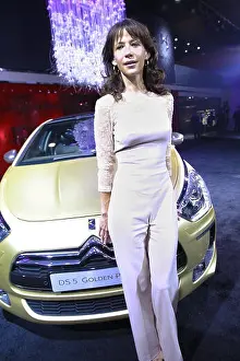 Guangdong Prints: French actress Sophie Marceau poses with a Changan PSAs Citroen DS5 Golden Pearl during the 11th China (Guangzhou)