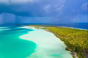 Tahiti Prints: French Polynesia Tahiti aerial drone view of Fakarava atoll and famous Blue Lagoon and motu island with perfect beach