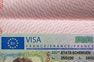 Approved Prints: french visa stamp inside open passport travel documents france immigration emigration concept europe tourism paperwork