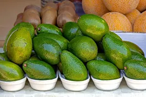 Fiber Prints: Fresh organic ripe avocado pile on market stall