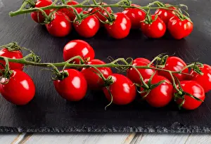 Fresh tomatoes on a black background. Selective focus