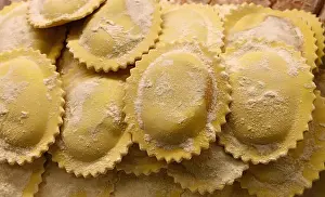 Stuffing Prints: Fresh traditional homemade rustic artisan gourmet Italian ravioli stuffed pasta in retail display