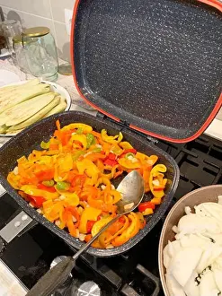 Eggplant Prints: Fresh vegetables like eggplant and peppers are prepared for making eggplant caviar in a home kitchen
