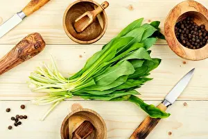 Fresh wild garlic on rustic vintage table, wild garlic dishes. Healthy cooking concept, top view