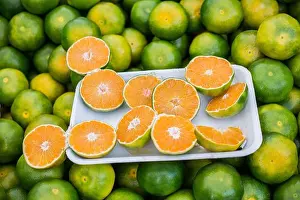 Oranges Prints: Freshly picked green tangerines mandarines, clementines, as Citrus fruit background
