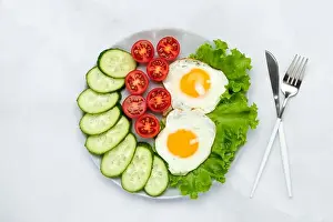 Tomatoes Prints: Fried chicken eggs with vegetables on a gray table