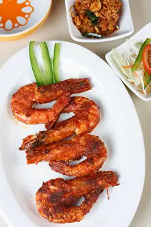 Shrimp Prints: Fried Prawn is a dish made by frying prawns in oil along with chilly powder and tomato